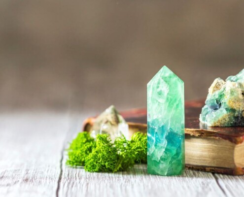Book with crystals on top and beside it.