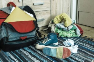 A teenager’s backpack, clothes, and shoes are scattered on their bedroom floor. We offer therapy for teens in Haddonfield and Medford, NJ. Get paired with a therapist today!