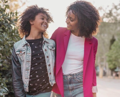 A mother & daughter walking side-by-side to school. Representing how teen therapy in Medford, NJ is here to support your teen this upcoming school year. Get them the personalized support they deserve!