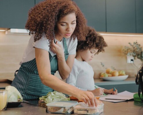 A mom multitasking during the morning routine with child.