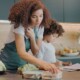 A mom multitasking during the morning routine with child.