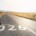 Female runner stretching on empty road with Start 2026 painted on asphalt, symbolizing new beginnings