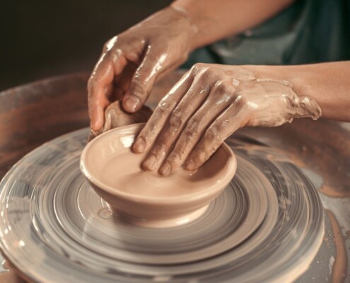 Hands shaping a ceramic cup on a pottery wheel, showcasing handmade craftsmanship. If you're interested in working with a Medford therapist, reach out to us today. We'll pair you with a compassionate, supportive counselor. 