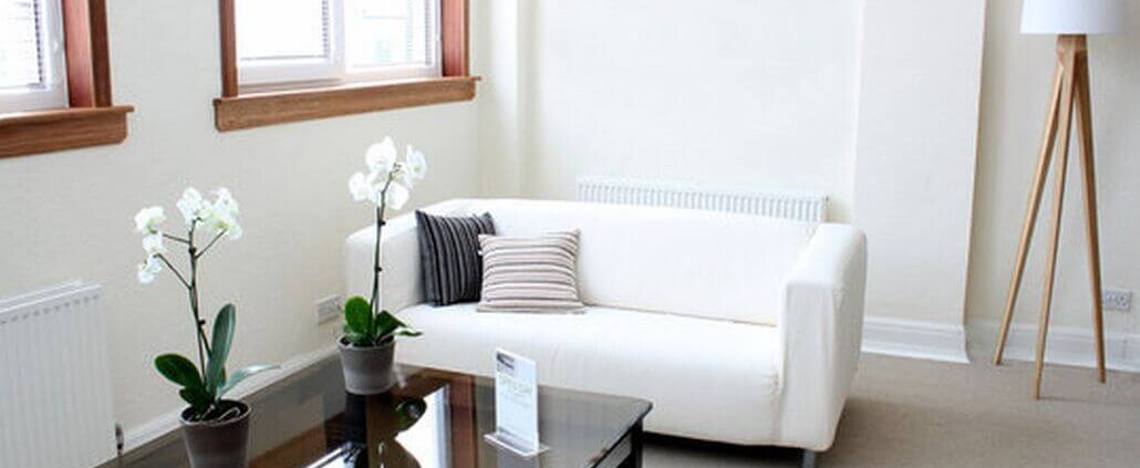 Bright waiting room with white sofa, glass coffee table, orchids, and minimalist decor. You don't have to have it all figured out to begin therapy in Medford, NJ. Reach out today to start working with a therapist. 