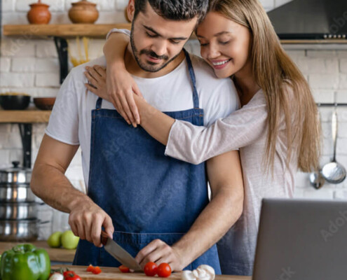Happy man and woman connecting while cooking together