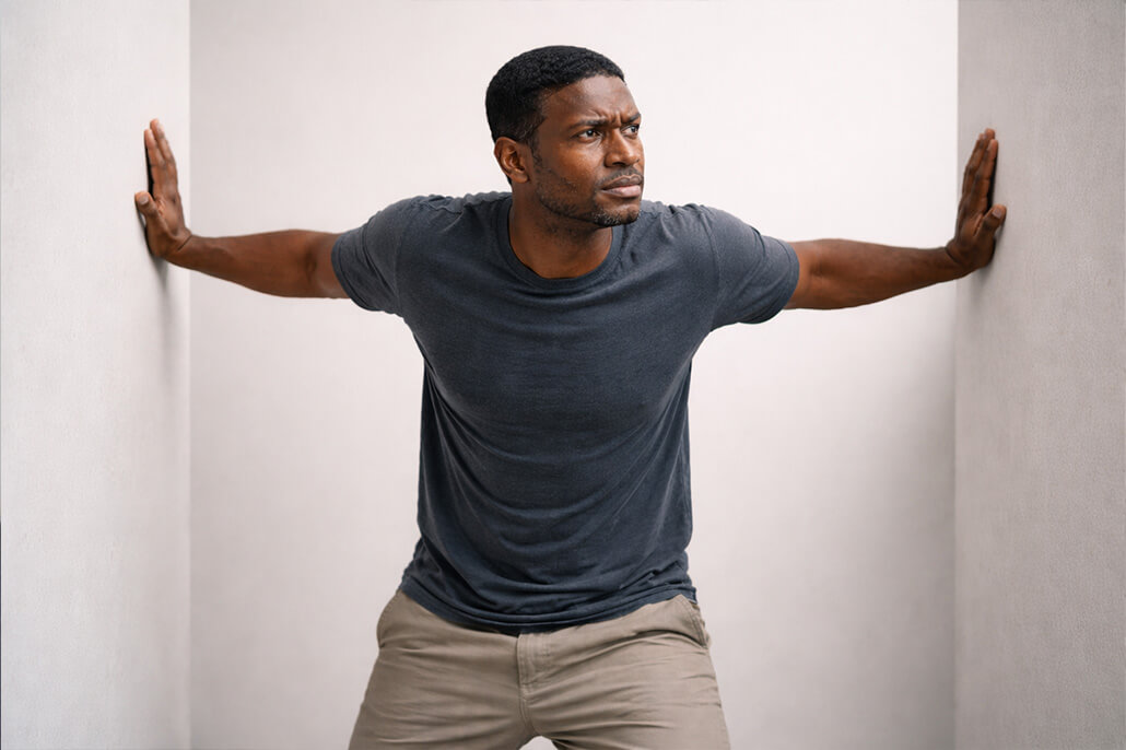 Man feeling stress like the walls are closing in on him